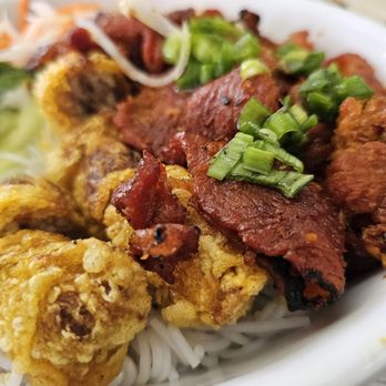 Grilled Pork and Egg Rolls Over Vermicelli Close-Up